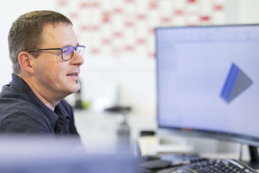 Spezialist bei Ebert Kunststoffbearbeitung arbeitet am Computer.